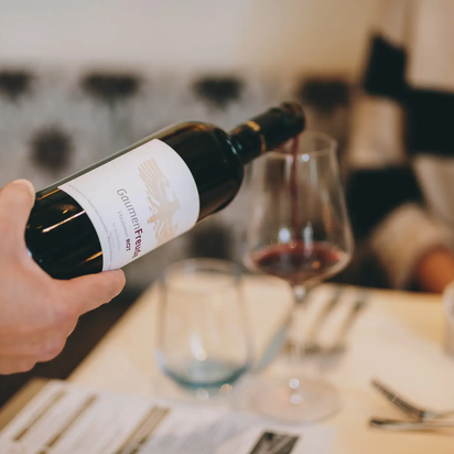 Red wine is poured into the glass