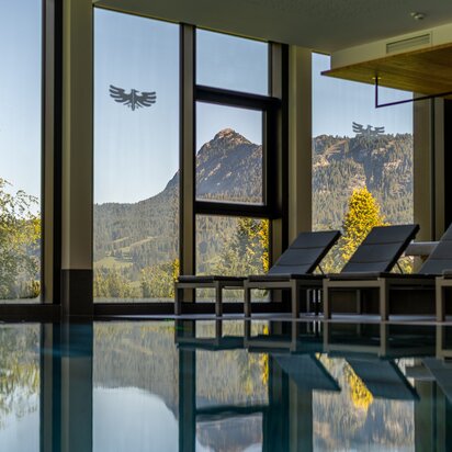 Swimming pool at Hotel Tyrol with mountain views