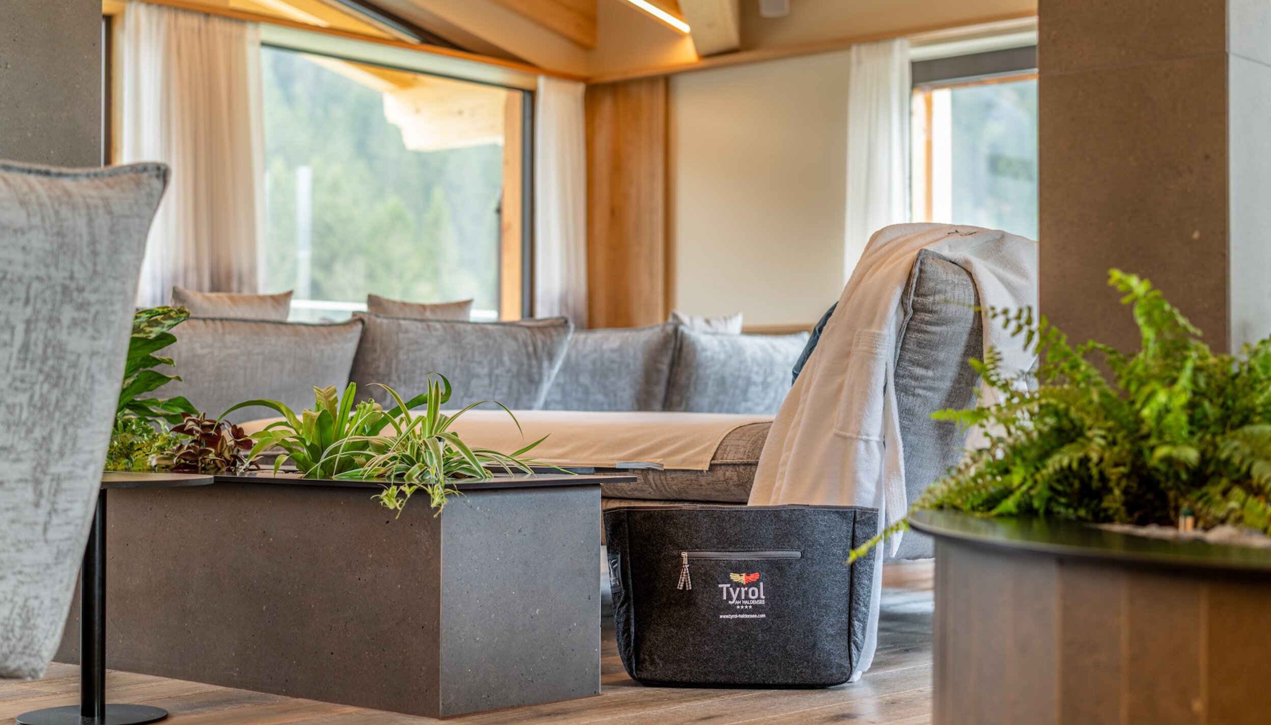 Hotel Tyrol relaxation room with sofa, table and plants