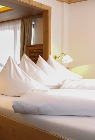 Hotel Tyrol Haldensee: Zimmer mit Bett und weißen Kissen